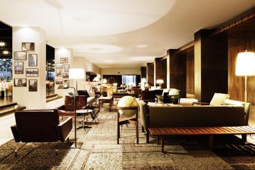 a lobby with couches and chairs in a building at Square Nine Hotel Belgrade-The Leading Hotels of The World in Belgrade