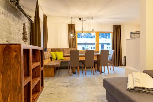 a kitchen and dining room with a table and chairs at Alpen Apart Heiss - DELUXE XL Apartments in Prutz