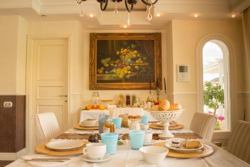 a dining room with a table with food on it at White House Luxury Hospitality in Olbia