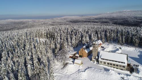 an aerial view of a house in the snow at Hotel Královka in Bedřichov