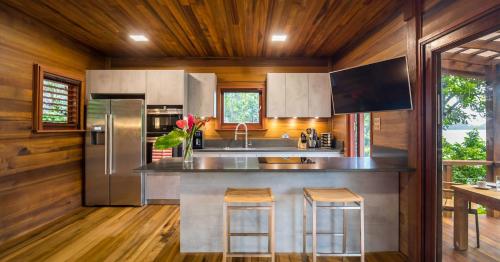 a kitchen with stainless steel appliances and wooden walls at Secret Bay in Portsmouth