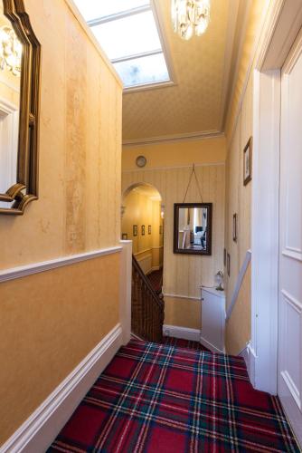 a hallway with a staircase with a skylight at Dunallan Guest House in Perth