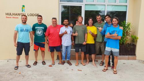 a group of people standing in front of a building at Hulhan'gu Lodge in Himmafushi