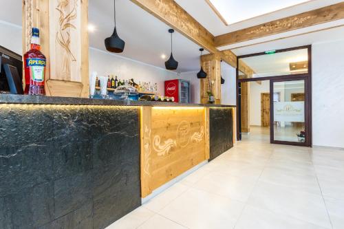 a bar with a black counter top in a room at Hotel Palatín in Oravský Podzámok