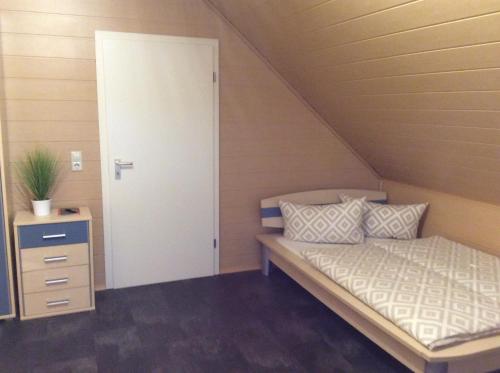 a small bedroom with a bed and a door at Apartment Jane in Bad Schonborn