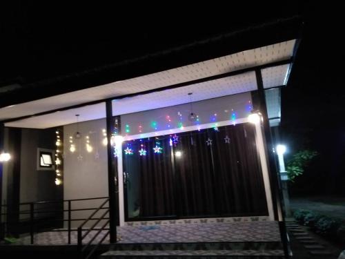 a house with lights on the side of it at night at Lek Village Khaoyai in Pak Chong
