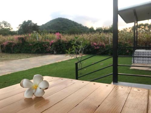 a flower sitting on top of a wooden table at Lek Village Khaoyai in Pak Chong