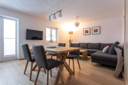 a living room with a table and a couch at Haus am Stein in Oetz