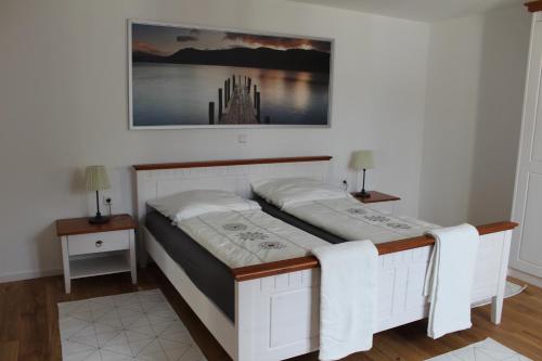 a bedroom with two beds and two night stands at Ferienwohnung in herrlicher Lage in Bad Urach
