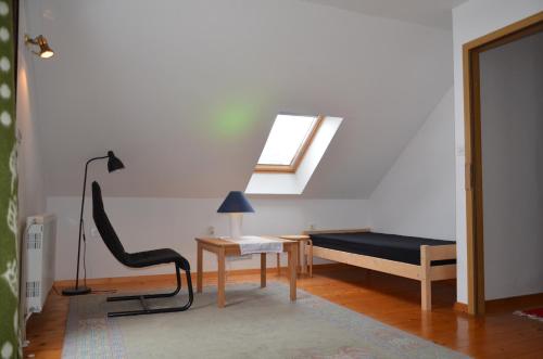 a living room with a bed and a skylight at Holiday House Bohinj in Bohinj