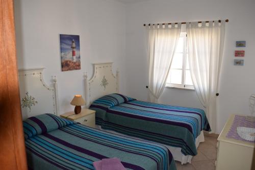 a bedroom with two beds and a window at CasaDuarte "Balcony" (2 bedroom Apt.) in Lagos