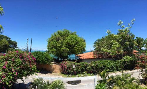 a house with trees and flowers on a street at Acuarela Hostal in Playa Blanca