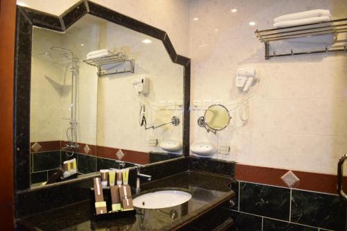 a bathroom with a sink and a mirror at Canary Beach Hotel in Yanbu