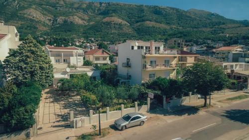 a car parked on a street in a town with houses at Apartments Sole Mar in Sutomore