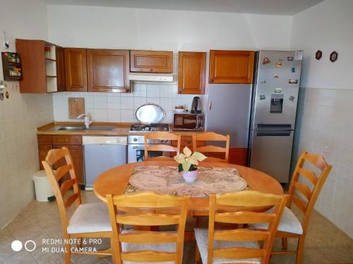 a kitchen with a table and chairs and a refrigerator at Apartment Bernarda in Igrane