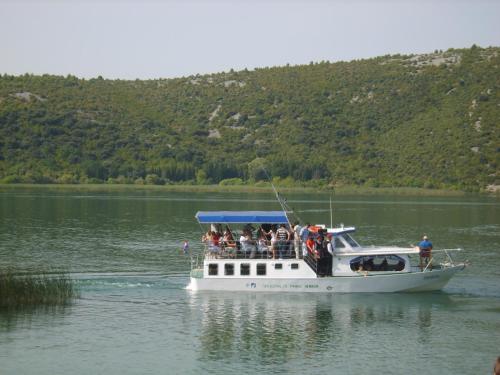 a group of people on a boat on a lake at Kuća za odmor "Joso" in Puljane
