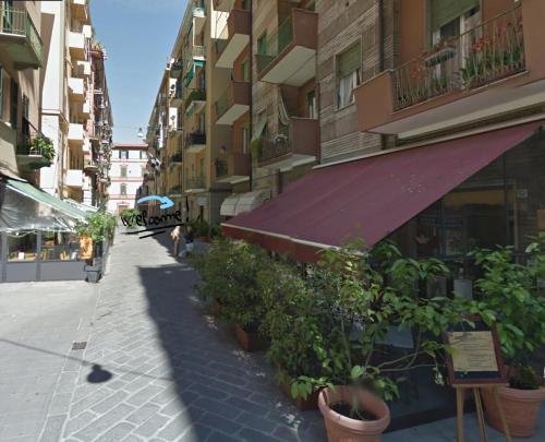an empty street with plants in pots on a building at Interno 10 in La Spezia