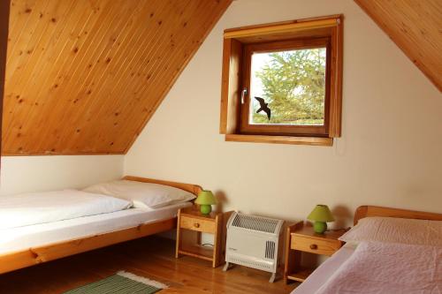 1 dormitorio con 2 camas y ventana en Chata Donovaly Buly 242/C, en Donovaly
