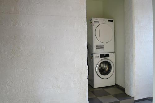 a washer and dryer in a corner of a room at Apartment in the country, great view Apt. B in Akureyri