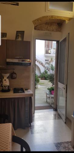a kitchen with an open door to a patio at La Culla di Adeodata in Marsala