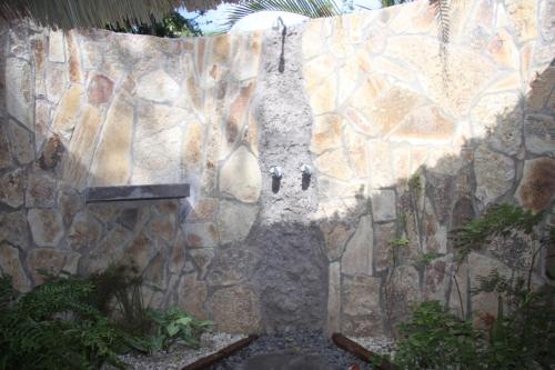 a stone wall with a statue on it at San Simian Lodge in La Laguna