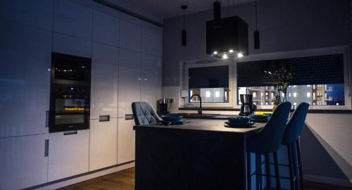 a kitchen with a island in the middle of a room at Apartament w Cieplicach Perfekt in Jelenia Góra