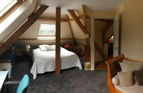 a bedroom with a white bed in a attic at Apartment in Romantic Villa in Bilthoven