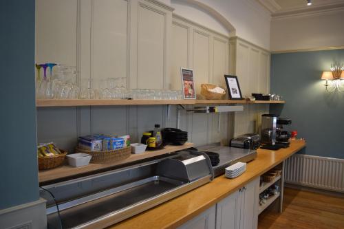 a kitchen with a sink and a counter top at Ambleside Townhouse in Ambleside