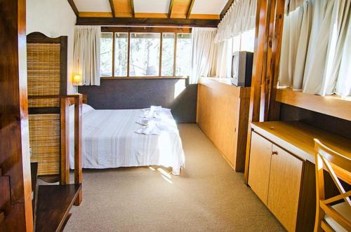Ένα ή περισσότερα κρεβάτια σε δωμάτιο στο Suites del Bosque