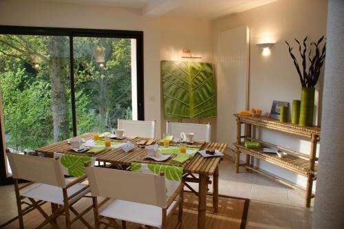 a dining room with a wooden table and chairs at La Villa Antalya in Ault