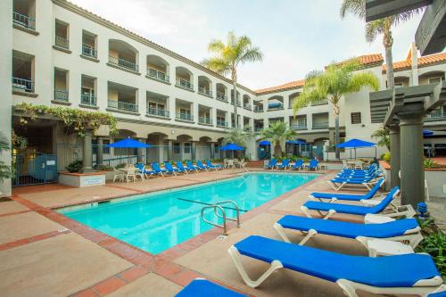 a swimming pool with lounge chairs and a hotel at Tamarack Beach Hotel in Carlsbad