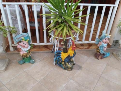 a group of figurines next to a potted plant at Kanalu Studio in Bouillante