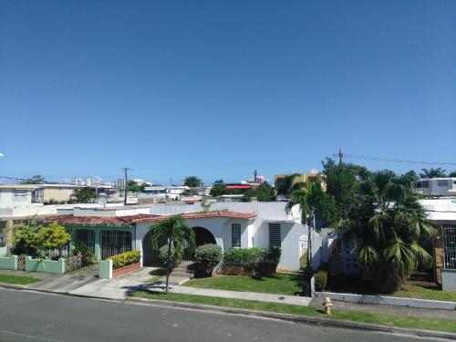 a view of a street with houses and palm trees at Urban Terrace Apartment in San Juan in San Juan