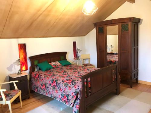 a bedroom with a large bed and a mirror at ADOBE TYPICAL COTTAGE in AlpalhÃ£o