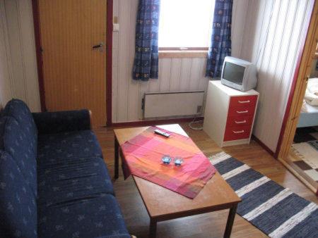 a living room with a couch and a coffee table at Seljestad Cottages in Skare