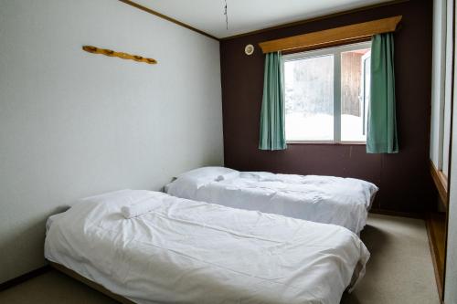 Absolute Niseko Lodgeにあるベッド