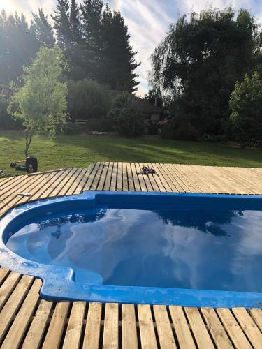 a pool on top of a wooden deck at Cabañas de Campo Colbún in Colbún