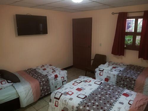Giường trong phòng chung tại Hotel Villa Angelo