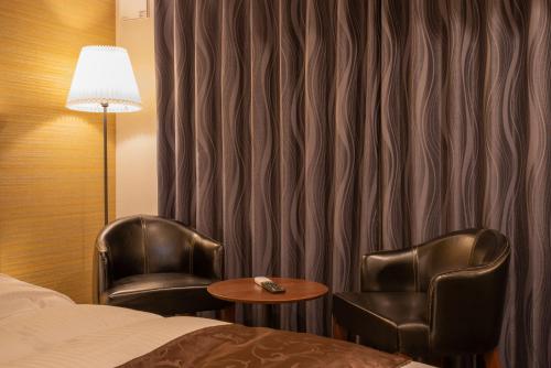 Ένα ή περισσότερα κρεβάτια σε δωμάτιο στο Zen Kyoto Apartment Hotel