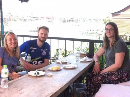 a group of three people sitting at a table at ST 63 Home Stay & Tour Kampong Khleang in Kâmpóng Khleăng