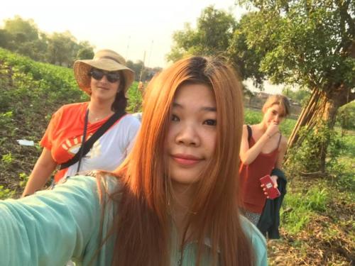 a girl with orange hair standing next to two women at ST 63 Home Stay & Tour Kampong Khleang in Kâmpóng Khleăng