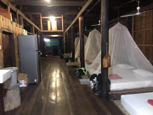 a room with a bunch of beds in it at ST 63 Home Stay & Tour Kampong Khleang in Kâmpóng Khleăng