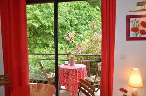 a room with a table and a large window at La Villa Antalya in Ault