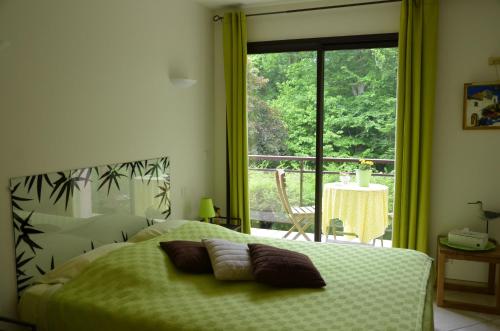 a bedroom with a bed and a window with a view at La Villa Antalya in Ault