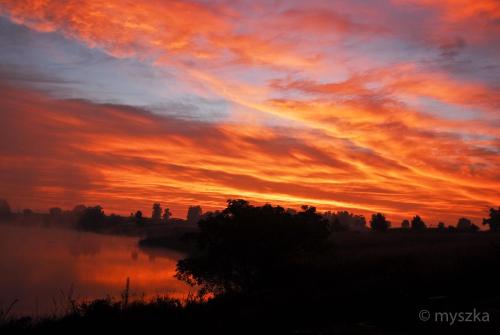 a sunset over a body of water with a sky at Wonderland in Winterton