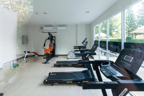 a gym with several treadmills and elliptical machines at Courtyard khaoyai by JP in Mu Si
