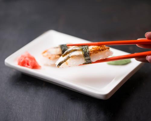 a plate of food with chopsticks on a table at Elegant Hotel & Resort in Tsaghkadzor