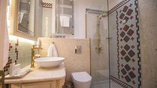 a bathroom with a sink and a toilet and a shower at Residence City Garden - Certificate of Excellence Top 10 BEST Five-Stars City Hotels for 2024 awarded by HTIF in Plovdiv