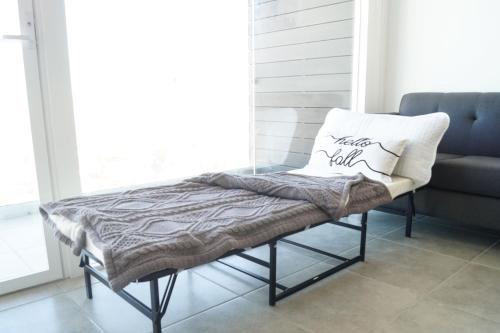 a bench with a pillow on it in a room at Luxurious Condo & unparalleled Comfort inTijuana in Tijuana