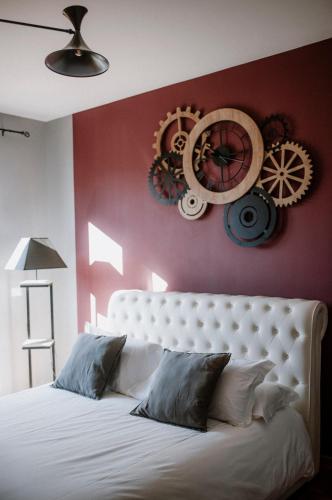a bedroom with a white bed and a red wall at Panoramic Villa Garassino - country rooms and fine restaurant in Treiso